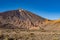 View of Roques de GarcÃ­a unique rock formation with famous Pico del Teide mountain volcano summit in the background on a sunset