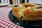 View of a Rosca de Reyes Epiphany Kings Cake on top of a red and white table cloth