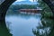 View from a round bridge over the small Chinese traditional huts on the edge of a lake