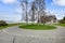 View of roundabout driveway and a green island