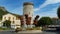 View on roundabout with medieval tower and flower decoration in french village