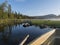 View from rowing boat on Fisherman man at lake Sjabatjakjaure in Beautiful sunny morning haze mist in Sweden Lapland nature.