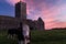 A view of the ruins of Clare Abbey a Augustinian monastery just outside Ennis, County Clare, Ireland with a beautiful sunset in
