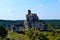 View of the ruins of the medieval castle of Mirowie nestled in a wooded landscape