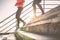 View of runners legs having a workout session on city stairs outdoor - Close up of people running at sunset