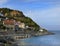 View of Runswick Bay on the east coast of North Yorkshire, with houses and a rocky mountain