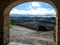 View of a rural landscape through the arched passage of Montfalco Murallat  fortified village in Catalonia Lleida, Spain.