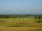 View of rural landscape in the morning mist, cereal fields in the distance