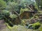 View on rusty ruins of old 19th century abandoned factory Fabrica da Cidade and Fabrica da Vila, lost in forest with