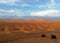 View of the Sahara desert with quads and camels