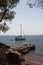 View of a sail boat, volcanic rocks and Aegean sea captured in Ayvalik area of Turkey.