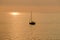 View on the sailboat in the ocean on the sunset in the golden light, close to the beach of Morro Jable on the Canary Island