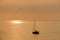 View on the sailboat in the ocean on the sunset in the golden light, close to the beach of Morro Jable on the Canary Island