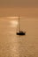 View on the sailboat in the ocean on the sunset in the golden light, close to the beach of Morro Jable on the Canary Island