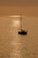 View on the sailboat in the ocean on the sunset in the golden light, close to the beach of Morro Jable on the Canary Island