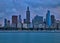 View of sailboats in a Lake Michigan marina with city of Chicago`s skyline in background during sunset.