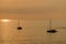 View on the sailboats in the ocean on the sunset in the golden light, close to the beach of Morro Jable on the Canary Island