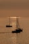 View on the sailboats in the ocean on the sunset in the golden light, close to the beach of Morro Jable on the Canary Island