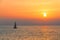 View of a sailing yacht on the background of a golden sunset from Venice fishing pier.California.USA