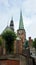 View of Saint James church and monument of german poet and playwright Emanuel von Geibel, Lubeck, Germany