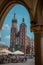 View of Saint Mary Basilica in Krakow, Poland on a summer sunny day viewed from the arcades at main city square