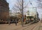 View from saint peters square in manchester looking down princess street with people walking past the tram stop