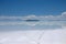 View of the salt lake of salar de uyuni in Bolivia showing tire tracks