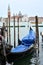 View of San Giorgio Maggiore church with ships transporting people around it and gondola in the foreground