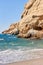 View of sandy beach, sealine, waves, cliff and blue sky in the summer sunny day