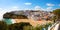 View of the sandy beach surrounded by typical white houses on a sunny spring day, Carvoeiro, Lagoa, Algarve, Portugal