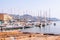 The view on Sanremo port full of sea boats, ships and yachts. Sanremo cityscape on the background