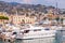 The view on Sanremo port full of sea boats, ships and yachts. Sanremo Old Town cityscape and Liguria landscape on the background