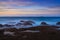 view of the Sant\\\'Antioco island coast and the Mangiabarche Lighthosue at sunrise on Sardinia