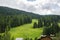 View of the Santa Fosca in summer, green hills and coniferous forest