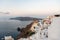 View of Santorini cliff houses and the Caldera at sunrise