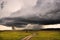 View of the savannah in Kenya with isolated heavy rain showers and big storm cloud