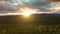 View of Scenic Valley surrounded by Mountains at Sunset