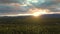 View of Scenic Valley surrounded by Mountains at Sunset