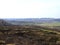 View of scorched grass on a field in early spring on the background of a creeping road Ukraine