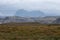 View of the Scottish Highlands near Lochinver, showing Mount Suilven in the background and heather in the foreground.