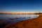 View of the sea and city lights reflection in it in the evening in Porto Cesareo