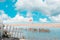 View of the sea coast with a single canopy. Blue cloudy sky. Copy space. World ocean day concept