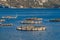 View of sea fish farm cages and fishing nets, farming dorado, sea bream and sea bass, feeding the fish a forage, with marine