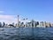 A view of the sea front at Toronto from a boat with a plane coming in to land