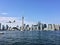 A view of the sea front at Toronto from a boat with a plane coming in to land