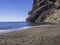 View on sea horizon with bout, black lava sand beach Playa De M