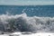 View of the sea horizon on a clear sunny day and the foamy wave of the surf