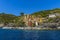 A view from the sea looking back across the harbour breakwater toward the Cinque Terre village of Riomaggiore, Italy