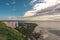 View of sea at low tide and empty beach with Chalk Cliff Arch in Margate, England