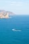 View of the sea and mountains. Curved trail of a scooter on the water surface